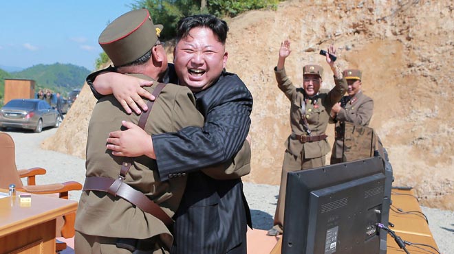 North Korean leader Kim Jong Un reacts with scientists and technicians of the DPRK Academy of Defence Science after the test-launch of Hwasong-14 in this undated photo released by KCNA